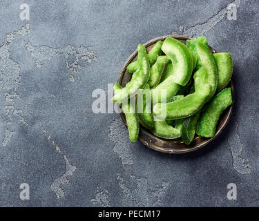 Dried pomelo slices on gray concrete background. Top view of candied fruits Stock Photo