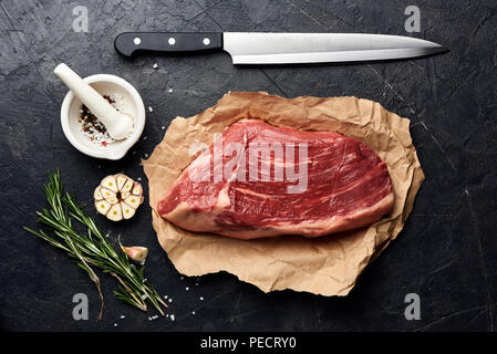 Raw fresh marbled meat Black Angus steak and meat knife. Stock Photo