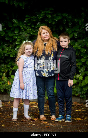 Cat Wilkinson, daughter of Michael Gallagher, with her daughter Fara, aged 8 and son Fynn, aged 10, outside the offices of Omagh Support & Self Help Group. Her brother 21-year-old Aiden Gallagher, who was killed in the Omagh bomb, had been preparing to emigrate to the United States. Stock Photo