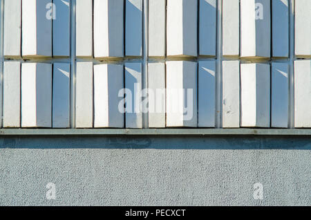 White wavy tiles in the decoration of the facade of the building. Stock Photo