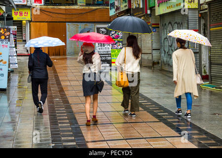 South Koreans with Umbrellas on Rainy Day Busan Pusan South Korea Asia Stock Photo