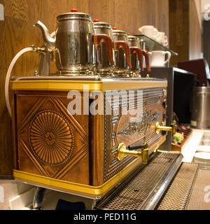 Traditional Turkish teapot by tea machine at the hotel Stock Photo