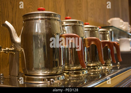 Traditional Turkish teapot by tea machine at the hotel Stock Photo