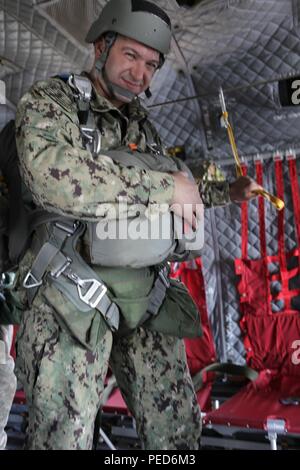 Military parachute riggers from multiple nations conduct a subject ...