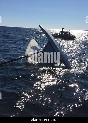 An overturned Hobie Cat is found floating in Lake Superior about four miles northwest of Grand Marais, Mich., Aug. 5, 2015.  The Coast Guard, searching with partnering agencies for a possible person in the water, is asking anyone with information about the vessel to contact the Sector Sault Ste. Marie Command Center at 906-635-3319. Stock Photo