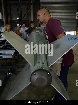 Chuck “The Iceman” Liddell, retired American mixed martial artist, inspects a guided bomb unit-31 on Osan Air Base, South Korea, Aug. 5, 2015. Liddell is a former Ultimate Fighting Championship Light Heavyweight Champion. He has an extensive striking background in Kempo, Koei-Kan karate, and kickboxing, as well as a grappling background in collegiate wrestling and Brazilian Jiu-Jitsu. (U.S. Air Force photo/ Senior Airman Kristin High) Stock Photo