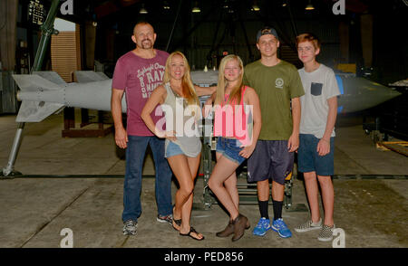 The Liddell family poses for a photo on Osan Air Base, South Korea, Aug. 5, 2015. Chuck “The Iceman” Liddell, retired American mixed martial artist, and his family visited various units across the base including fire department, the fitness center, and the munitions section during a morale trip. Liddell is a former Ultimate Fighting Championship Light Heavyweight Champion. (U.S. Air Force photo/Senior Airman Kristin High) Stock Photo