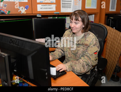 U.S. Air Force Senior Airman Sheral Bair, 455th Expeditionary Logistics Readiness Squadron log planner, works on passenger terminal schedules Aug. 4, 2015, at Bagram Air Field, Afghanistan. Bair is a member of the PAX terminal team who is responsible for ensuring all Bagram Airmen redeploy back to home station when they reach the end of their tour here. (U.S. Air Force photo by Senior Airman Cierra Presentado/Released) Stock Photo