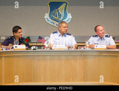 Bangladesh Air Force Air Commodore Hasan Khan (left), Bangladesh Air Force plans director, U.S. Air Force Maj. Gen. Abel Barrientes (center), Pacific Air Forces vice commander's individual mobility assitant, and Col. Joseph Anderson (right), Pacific Air Forces surgeon general, participate in Airman-to-Airman Talks, Joint Base Pearl Harbor-Hickam, Hawaii, Aug. 4, 2015. The aim of the inaugural U.S. and Bangladesh Airman-to-Airman Talks was to bolster an earnest relationship between key leaders and pave the way for future cooperation among the two air forces. Discussion topics focused on a numbe Stock Photo