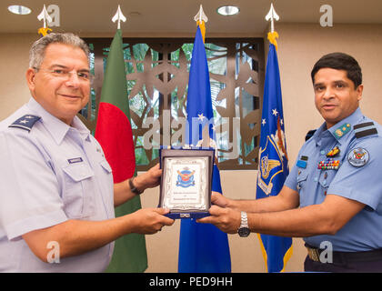 U.S. Air Force Maj. Gen. Abel Barrientes (left), Pacific Air Forces vice commander's individual mobility assistant and Bangladesh Air Force Air Commodore Hasan Khan (right), Bangladesh Air Force plans director, exchange gifts after concluding Airman-to-Airman Talks, Joint Base Pearl Harbor-Hickam, Hawaii, Aug. 6, 2015. The aim of the inaugural U.S. and Bangladesh Airman-to-Airman Talks was to bolster an earnest relationship between key leaders and pave the way for future cooperation among the two air forces. Discussion topics focused on a number of key matters which will enable both countries  Stock Photo
