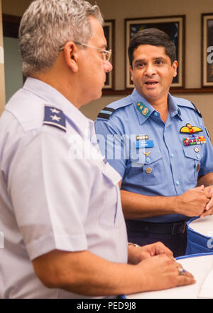 Bangladesh Air Force Air Commodore Hasan Khan, Bangladesh Air Force plans director, speaks to U.S. Air Force Maj. Gen. Abel Barrientes, Pacific Air Forces vice commander's individual mobility assistant, during U.S. and Bangladesh Airman-to-Airman Talks, Joint Base Pearl Harbor-Hickam, Hawaii, Aug. 6, 2015. The aim of the inaugural U.S. and Bangladesh Airman-to-Airman Talks was to bolster an earnest relationship between key leaders and pave the way for future cooperation among the two air forces. Discussion topics focused on a number of key matters which will enable both countries to plan futur Stock Photo