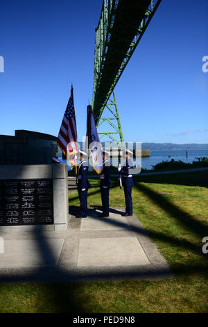 A Coast Guard color guard from Sector Columbia River in Warrenton, Ore., stands at attention prior to a flag ceremony commencing the Seaman's Memorial ceremony held at Maritime Memorial Park in Astoria, Aug. 7, 2015. The Seaman's Memorial is held annually in conjunction with the Astoria Regatta in remembrance of those who had lost their life in the Columbia River or at sea. (U.S. Coast Guard photo by Petty Officer 1st Class Levi Read) Stock Photo