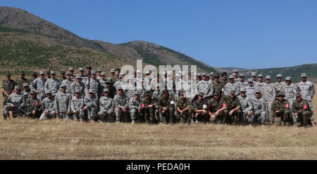 U.S. Army Soldiers, currently assigned to Multinational Battle Group-East, pose for a group photo alongside their German instructors after competing in a shooting event to earn the German Armed Forces Proficiency Badge, a traditional military award for Germany's troops, Aug. 1, 2015, in Prizren, Kosovo. (U.S Army photo by Sgt. Gina Russell) Stock Photo