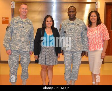 Col. Scott Linton, 311th Expeditionary Sustainment Command chief of staff, the Honorable Debra S. Wada, Assistant Secretary of the Army, Manpower & Reserve Affairs, Comannd Sgt. Maj. Grady Blue, 311th ESC command sergeant major, and 63rd Brigade Support Battalion Supervisory Staff Administrator Ms. Teresa M. Gonzalez, tour the George W. Dunaway Army Reserve Center’s drill hall in Sloan, Nevada Aug. 7. Stock Photo