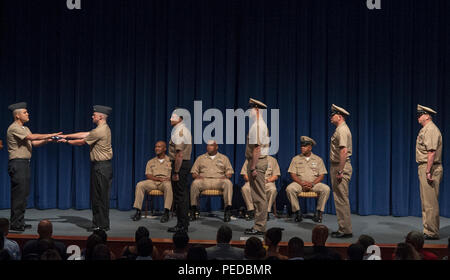 150807-N-TT082-089  NEWPORT NEWS, Va.  (August 7, 2015) Nimitz-class aircraft carrier USS Abraham Lincoln’s (CVN 72) Sailors participate in the Passing of the Flag presentation during Master Chief Electronics Technician Christopher H. Miles’ retirement ceremony at Gaines’s Theatre on Christopher Newport University campus, Aug. 7. Miles retired after 26 years of service in the United States Navy. (U.S. Navy photo by Mass Communication Specialist 3rd Class Ryan Wampler/Released) Stock Photo