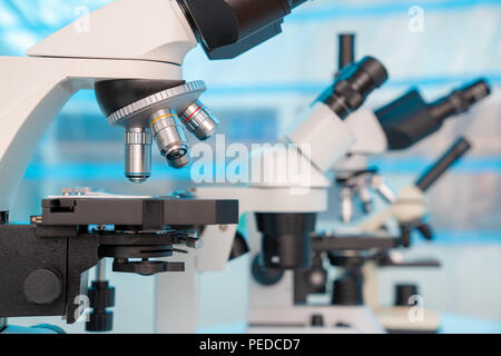 Four microscopes of different designs in the laboratory Stock Photo