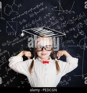 Little genius female child on hand drawings math science formula pattern. Kids mathematics education concept Stock Photo