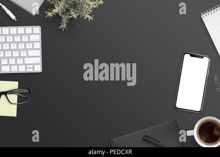 Work desk flat lay concept. Black desk with free space in the middle. Stock Photo