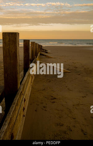 A single groyne at Sandown beach on the Isle of Wight, Hampshire, UK used to prevent the erosion of the beach and movement of the sand. Stock Photo