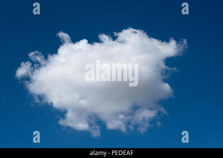 Single cloud against a blue sky. Stock Photo