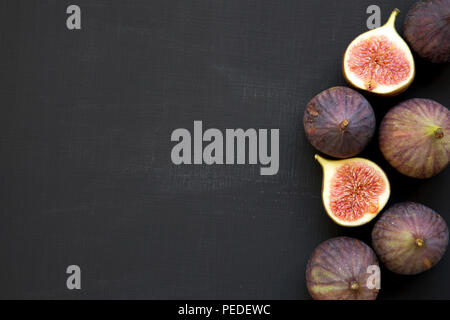 Fresh figs on black background, top view. From above, overhead. Copy space. Stock Photo