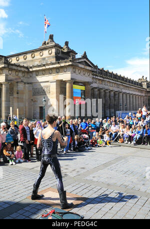 Sword swallower, Slug, from Tasmiania, performing by the Royal Scottish Academy on the Mound, in Edinburgh's Fringe Festival 2018, in Scotland, UK Stock Photo