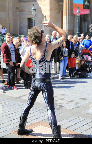 Sword swallower, Slug, from Tasmiania, performing by the Royal Scottish Academy on the Mound, in Edinburgh's Fringe Festival 2018, in Scotland, UK Stock Photo