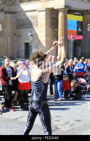 Sword swallower, Slug, from Tasmiania, performing by the Royal Scottish Academy on the Mound, in Edinburgh's Fringe Festival 2018, in Scotland, UK Stock Photo