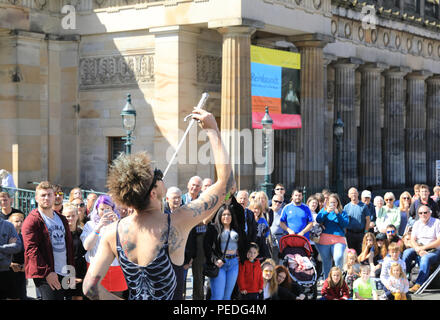 Sword swallower, Slug, from Tasmiania, performing by the Royal Scottish Academy on the Mound, in Edinburgh's Fringe Festival 2018, in Scotland, UK Stock Photo