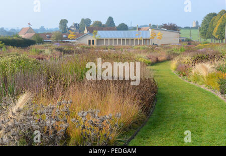 View across Oudolf Field designed by landscape architect Piet Oudolf to the main gallery building of Hauser & Wirth, Bruton, Somerset, England Stock Photo