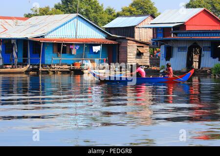 TONLE SAP, CAMBODIA - DECEMBER 11, 2013: Unidentified people go about their daily life in floating village on Tonle Sap lake. It is the largest lake i Stock Photo
