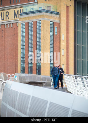 People on the Millennium bridge over the River Tyne with The Baltic in the background Stock Photo