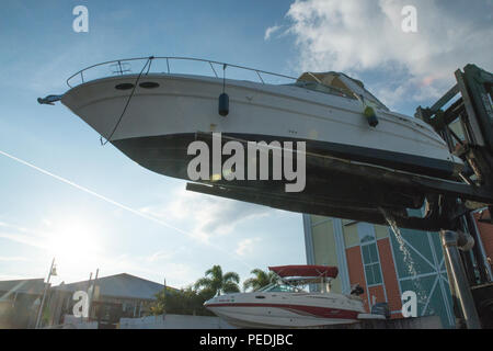 A 32-foot boat is shown lifted out of the water at Hula Bay Marina, Tampa, Fla., Monday, Aug. 10, 2015. Crew members from Coast Guard Station St. Petersburg, Fla., rescued a couple and their two dogs, after the boat began taking on water five miles south of the Gandy Bridge, in Tampa. (U.S. Coast Guard photo by Petty Officer 3rd Class Ashley J. Johnson) Stock Photo