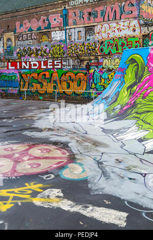 skate park covered in street art at Dean Lane, Bedminster, Bristol on a wet rainy day in August Stock Photo