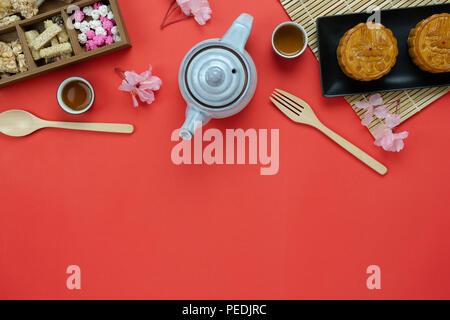 Table top view aerial image of decorations Chinese Moon Festival background concept.Flat lay meal set of coffee break the sweet cake & tea pot with sn Stock Photo