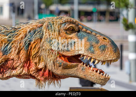 Life size creature from Walking with Dinosaurs - the $20 million arena spectacular walking around the streets of Gothenburg Stock Photo