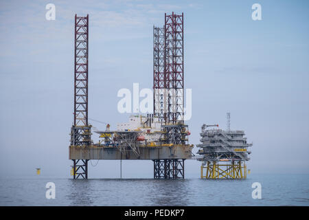 Atlantic Amsterdam jacked up adjacent to Offshore Substation (OSS) Z01 on Race Bank Offshore Wind Farm, UK Stock Photo