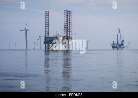 Atlantic Amsterdam jacked up adjacent to Offshore Substation (OSS) Z01 on Race Bank Offshore Wind Farm, UK. A2Sea's jack-up vessel, Sea Installer, is seen in the distance. Stock Photo