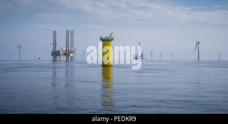 Atlantic Amsterdam jacked up adjacent to Offshore Substation (OSS) Z01 on Race Bank Offshore Wind Farm, UK. A2Sea's jack-up vessel, Sea Installer, is seen in the distance. Stock Photo