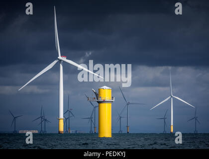 Storm clouds provide a dramatic backdrop to the Siemens wind turbines of the Walney offshore wind farm Stock Photo