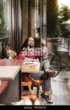 Nice bearded man sitting in the cafeteria Stock Photo