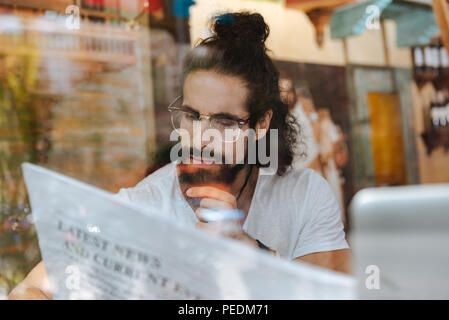 Serious thoughtful man reading an article Stock Photo