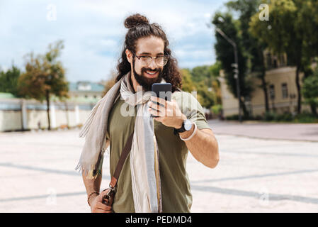 Happy nice man looking at the smartphone screen Stock Photo