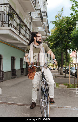 Pleasant nice man using a bicycle Stock Photo