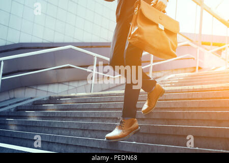 Cropped picture of businessman walking down stairs. Stock Photo