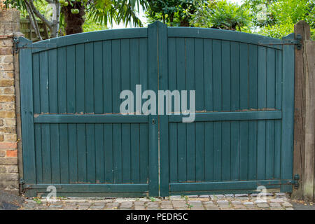 Double green driveway and garden gates. Stock Photo