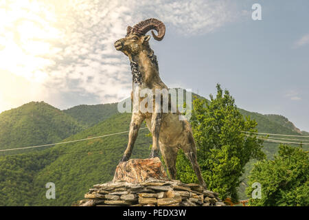 Ram statue with mountain landscape background. Stock Photo