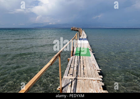 floating pier at Kalamaki beach at Corfu Island (Greece). On the other side of adriatic sea is aabian city Sarande located. Stock Photo