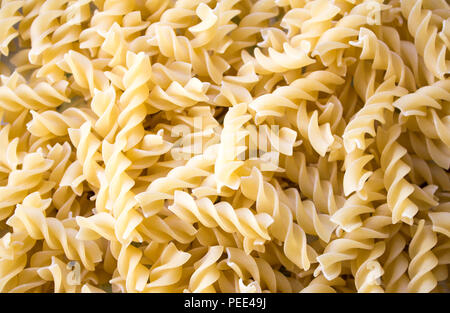 Dry pasta background, healthy food, yellow background Stock Photo