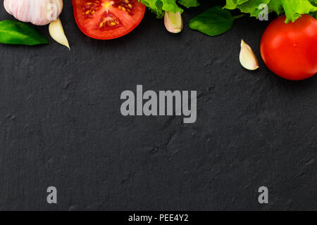 Pasta, vegetables, herbs and spices for Italian food on black background, top view, copy space. Stock Photo